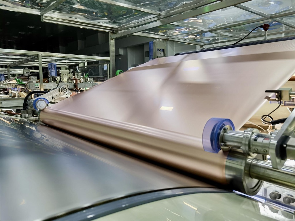 Thin battery copper foil moving through production rollers